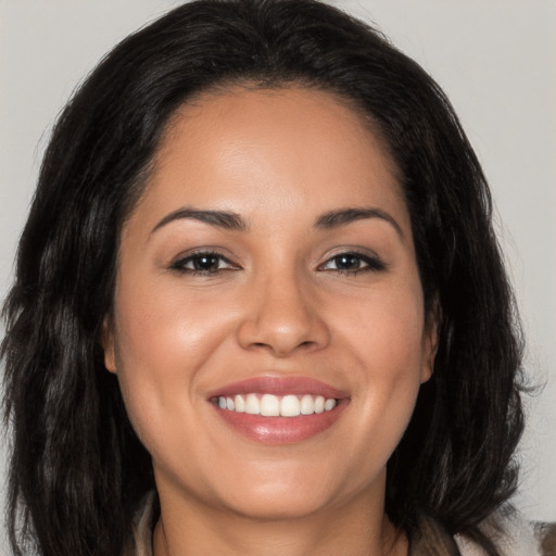 Joyful latino young-adult female with medium  brown hair and brown eyes