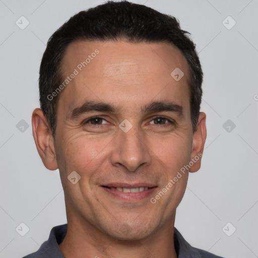 Joyful white adult male with short  brown hair and brown eyes