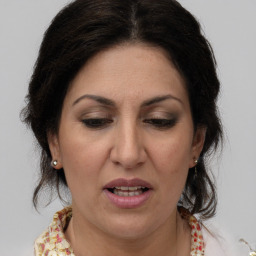 Joyful white adult female with medium  brown hair and brown eyes