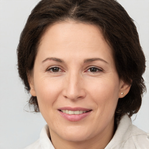 Joyful white adult female with medium  brown hair and brown eyes