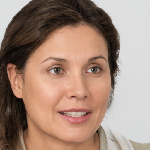 Joyful white adult female with medium  brown hair and brown eyes