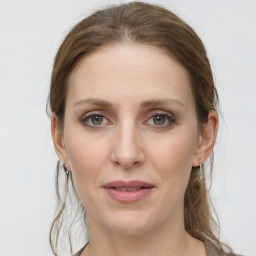 Joyful white young-adult female with medium  brown hair and grey eyes