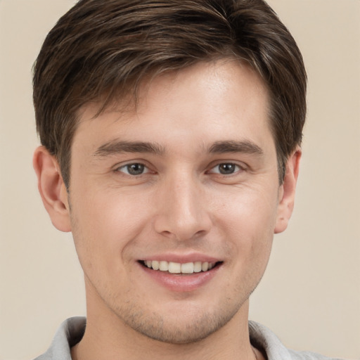 Joyful white young-adult male with short  brown hair and brown eyes