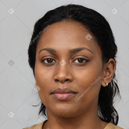 Joyful black young-adult female with medium  black hair and brown eyes