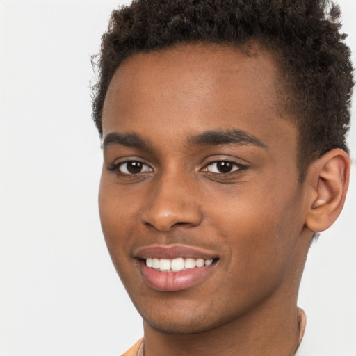 Joyful black young-adult male with short  brown hair and brown eyes