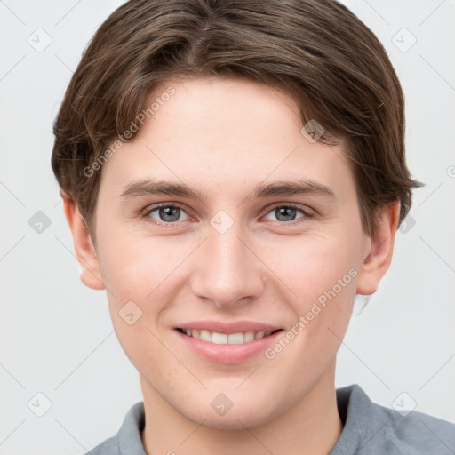 Joyful white young-adult female with short  brown hair and grey eyes