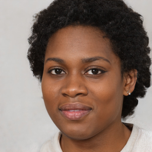 Joyful black young-adult female with medium  black hair and brown eyes