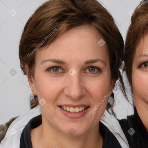 Joyful white adult female with medium  brown hair and blue eyes