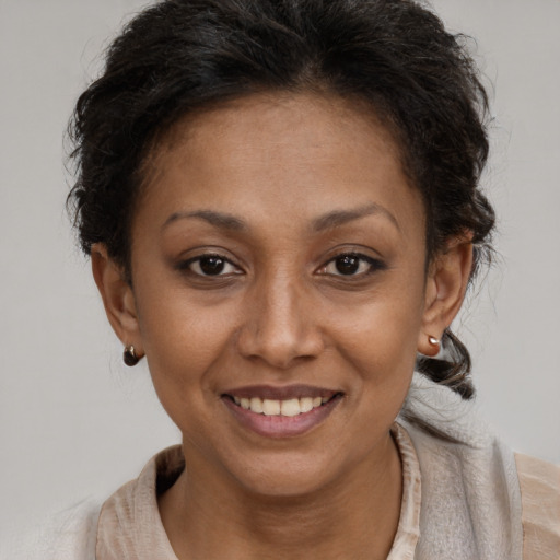 Joyful latino young-adult female with short  brown hair and brown eyes