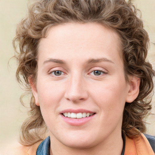 Joyful white young-adult female with medium  brown hair and blue eyes