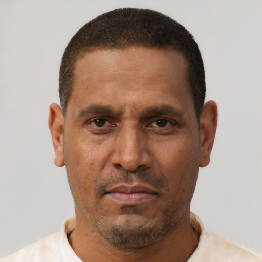 Neutral latino adult male with short  brown hair and brown eyes