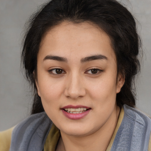Joyful latino young-adult female with medium  brown hair and brown eyes