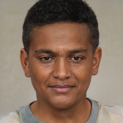 Joyful black young-adult male with short  brown hair and brown eyes