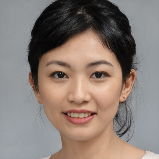 Joyful asian young-adult female with medium  black hair and brown eyes