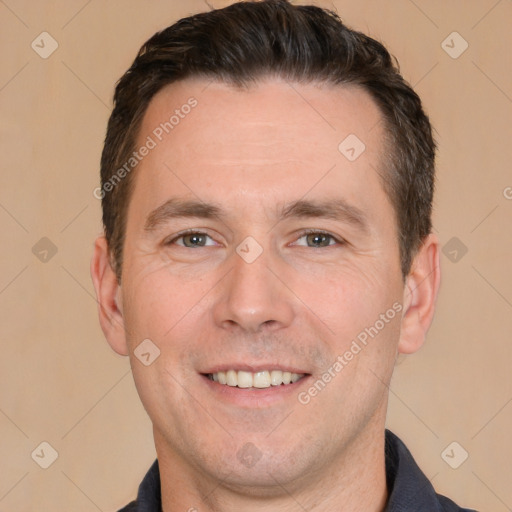 Joyful white adult male with short  brown hair and brown eyes