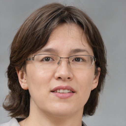 Joyful white adult female with medium  brown hair and brown eyes