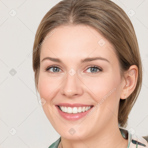 Joyful white young-adult female with medium  brown hair and green eyes