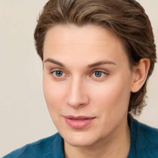 Joyful white young-adult female with short  brown hair and grey eyes