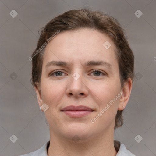 Joyful white young-adult female with short  brown hair and grey eyes