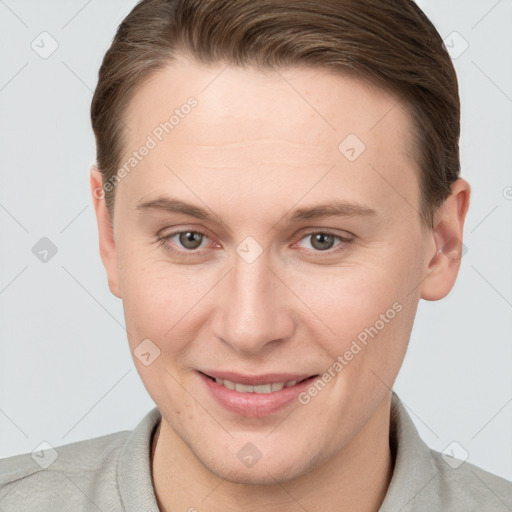 Joyful white young-adult female with short  brown hair and grey eyes