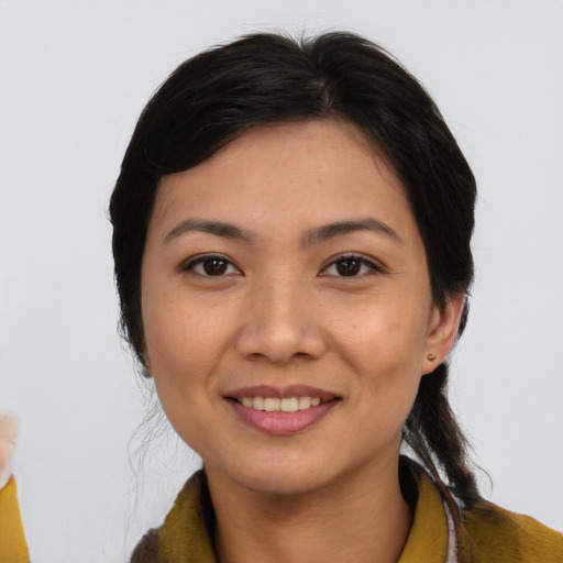 Joyful asian young-adult female with short  black hair and brown eyes