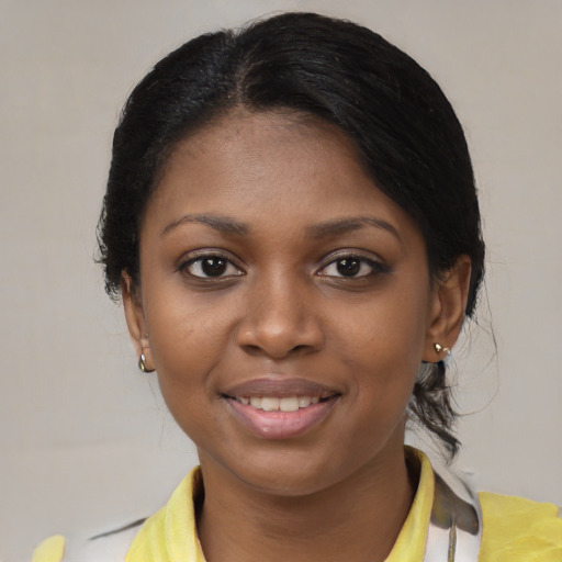 Joyful black young-adult female with medium  brown hair and brown eyes