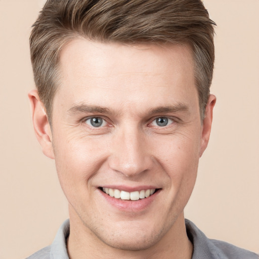 Joyful white adult male with short  brown hair and grey eyes