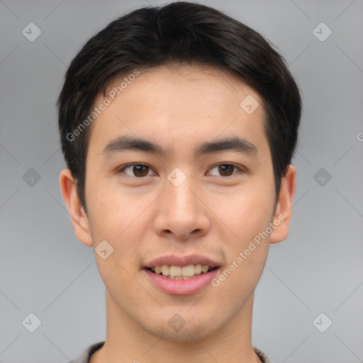 Joyful asian young-adult male with short  brown hair and brown eyes