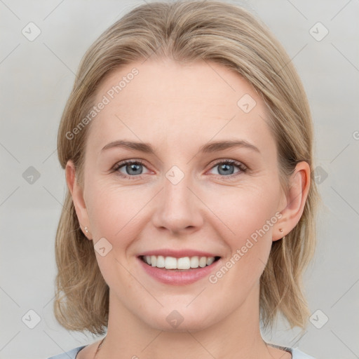 Joyful white young-adult female with medium  brown hair and blue eyes