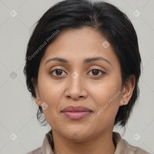 Joyful latino adult female with medium  brown hair and brown eyes