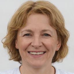 Joyful white adult female with medium  brown hair and blue eyes