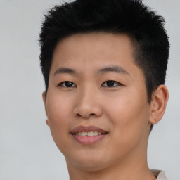 Joyful asian young-adult male with short  black hair and brown eyes