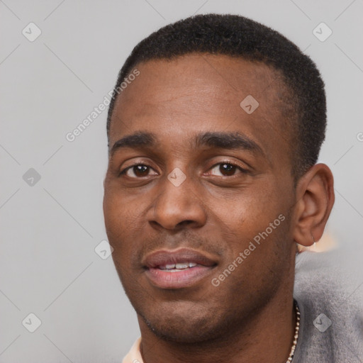 Joyful black young-adult male with short  black hair and brown eyes