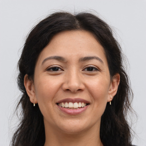 Joyful asian young-adult female with long  brown hair and brown eyes