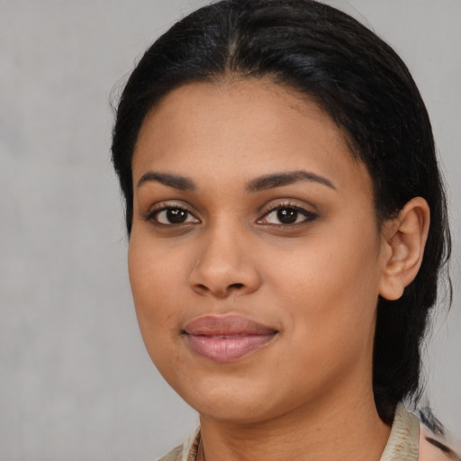 Joyful black young-adult female with medium  black hair and brown eyes