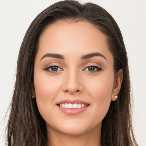 Joyful white young-adult female with long  brown hair and brown eyes