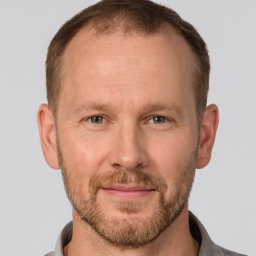 Joyful white adult male with short  brown hair and grey eyes