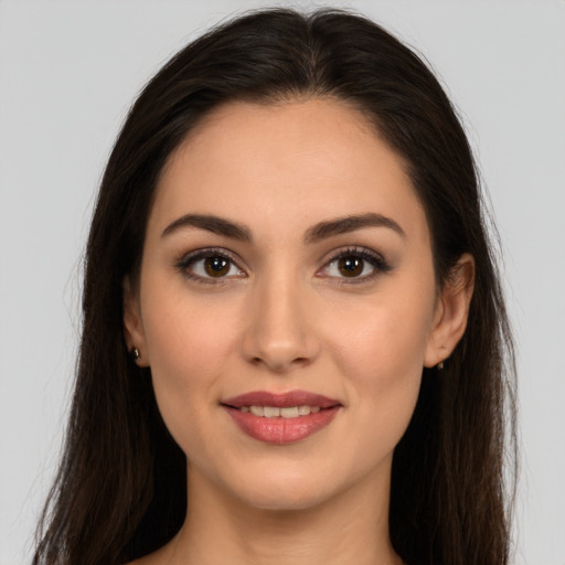 Joyful white young-adult female with long  brown hair and brown eyes