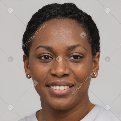 Joyful black young-adult female with short  black hair and brown eyes