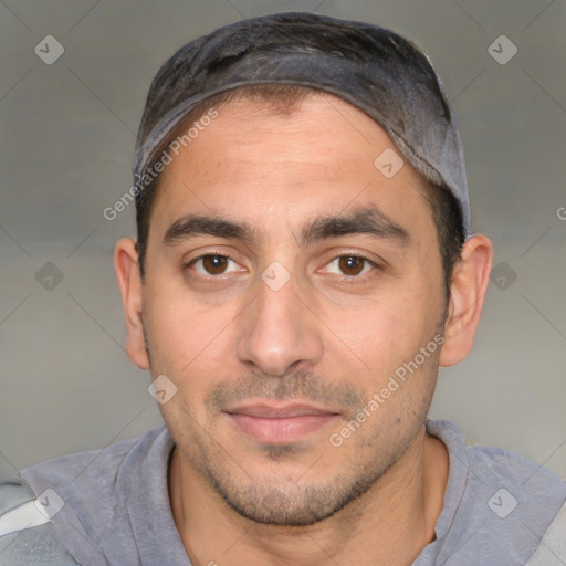 Joyful white young-adult male with short  black hair and brown eyes