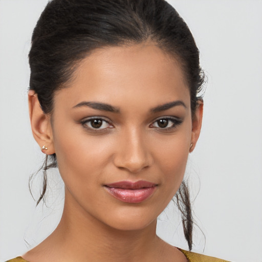 Joyful latino young-adult female with medium  brown hair and brown eyes