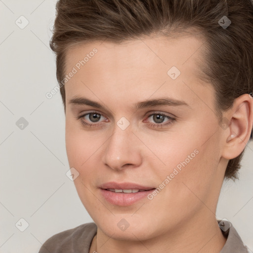 Joyful white young-adult female with short  brown hair and brown eyes