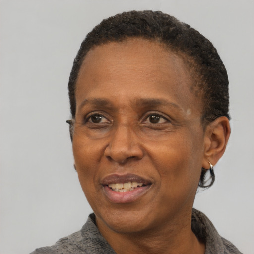Joyful black adult female with short  black hair and brown eyes