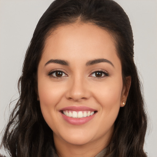 Joyful white young-adult female with long  brown hair and brown eyes