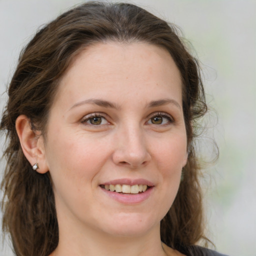 Joyful white young-adult female with medium  brown hair and green eyes