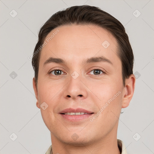 Joyful white young-adult male with short  brown hair and grey eyes