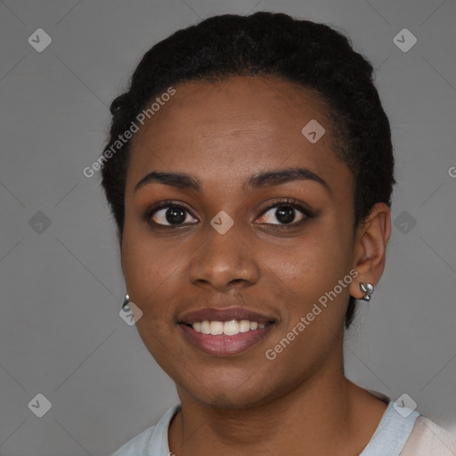 Joyful black young-adult female with short  black hair and brown eyes