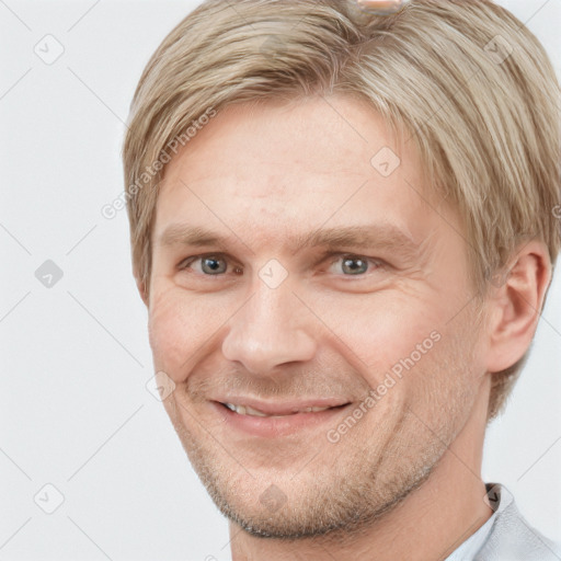 Joyful white adult male with short  brown hair and grey eyes