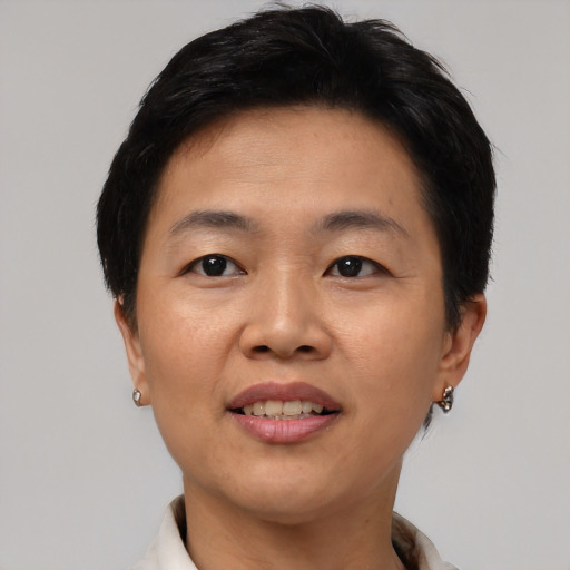Joyful asian young-adult female with short  brown hair and brown eyes