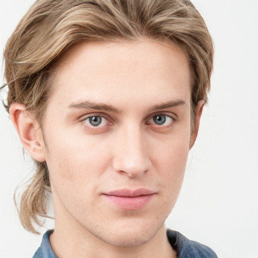 Joyful white young-adult male with short  brown hair and blue eyes